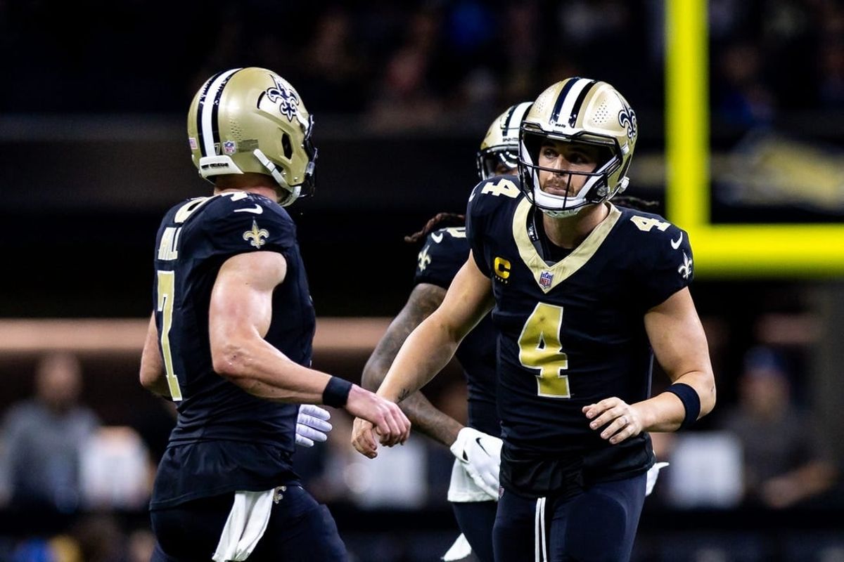 Dec 3, 2023; New Orleans, Louisiana, USA; New Orleans Saints quarterback Derek Carr (4) talks to quarterback Taysom Hill (7) against the Detroit Lions during the first half at the Caesars Superdome.