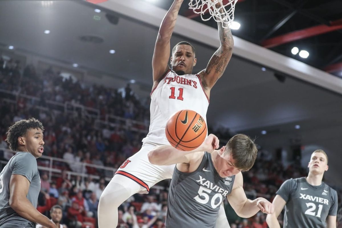 Dec 20, 2023; Queens, New York, USA; St. John's Red Storm center Joel Soriano (11) dunks over Xavier Musketeers forward Gytis Nemeiksa (50) in the second half at Carnesecca Arena.