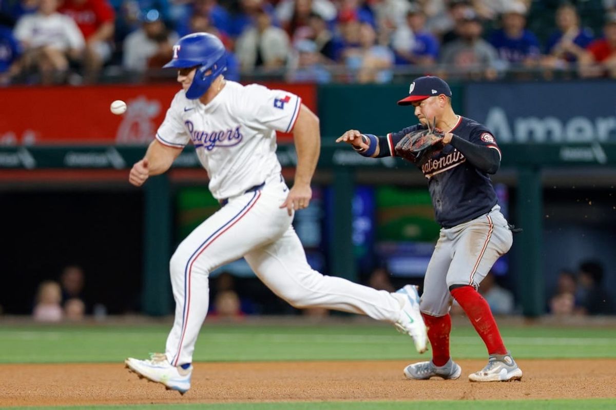 May 1, 2024; Arlington, Texas, USA; Washington Nationals second base Ildemaro Vargas (14) starts a double play during the fourth inning against the Texas Rangers at Globe Life Field.