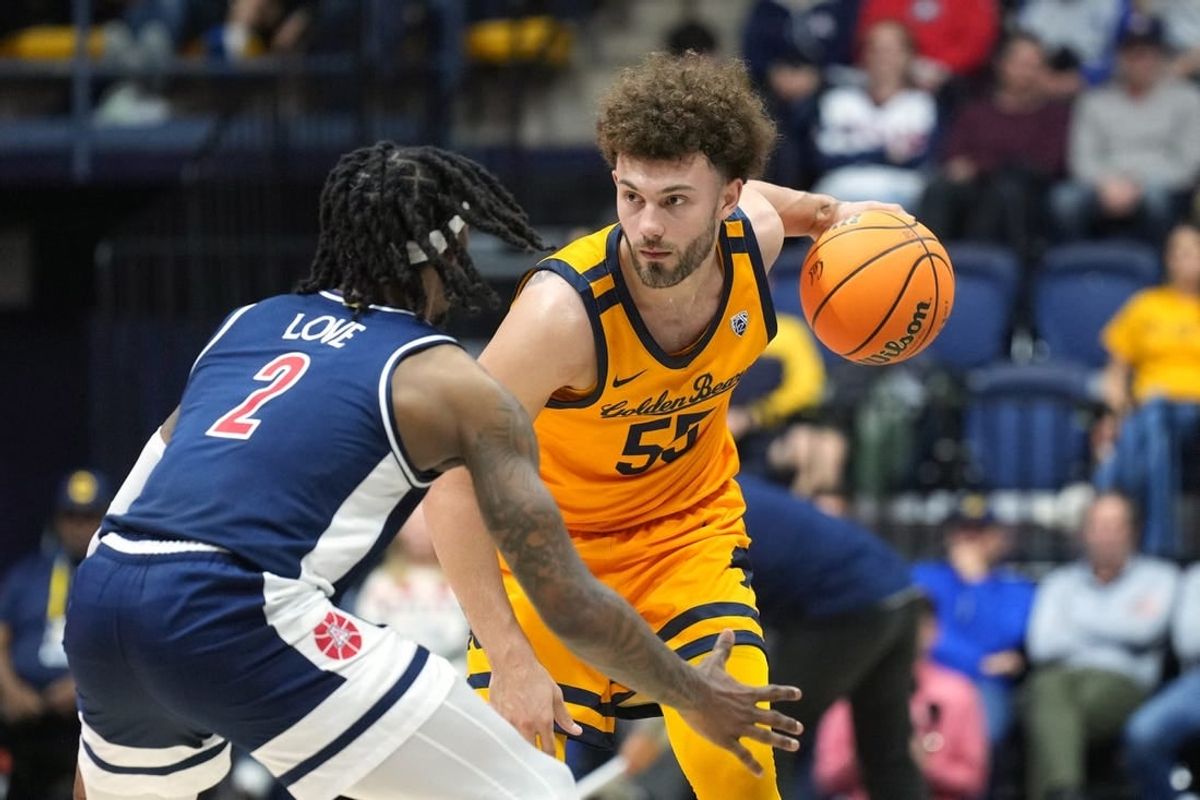 Dec 29, 2023; Berkeley, California, USA; California Golden Bears guard Devin Askew (55) handles the ball against Arizona Wildcats guard Caleb Love (2) during the first half at Haas Pavilion.