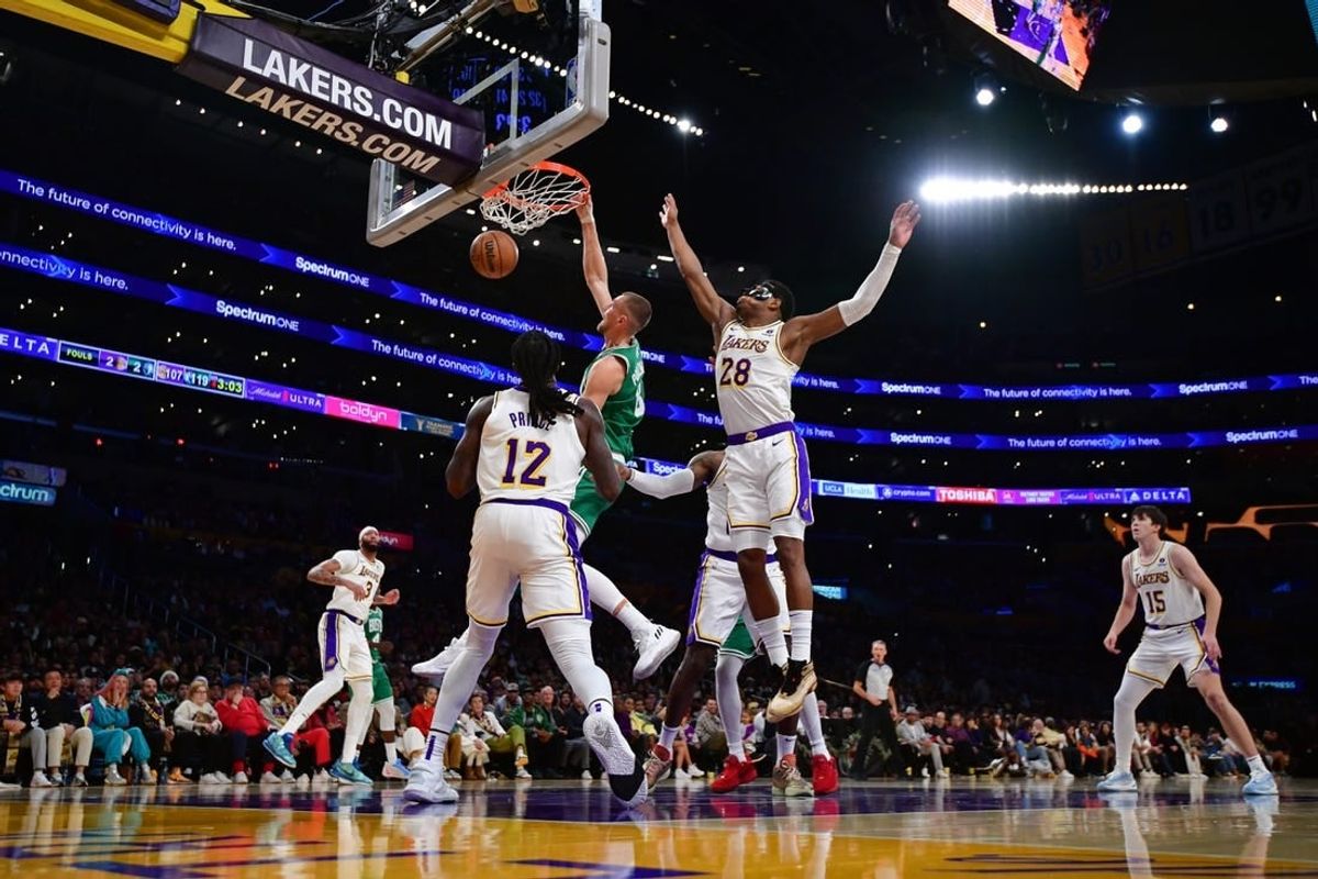 Dec 25, 2023; Los Angeles, California, USA; Boston Celtics center Kristaps Porzingis (8) dunks for the basket against Los Angeles Lakers forward Rui Hachimura (28) and forward Taurean Prince (12) during the second half at Crypto.com Arena.