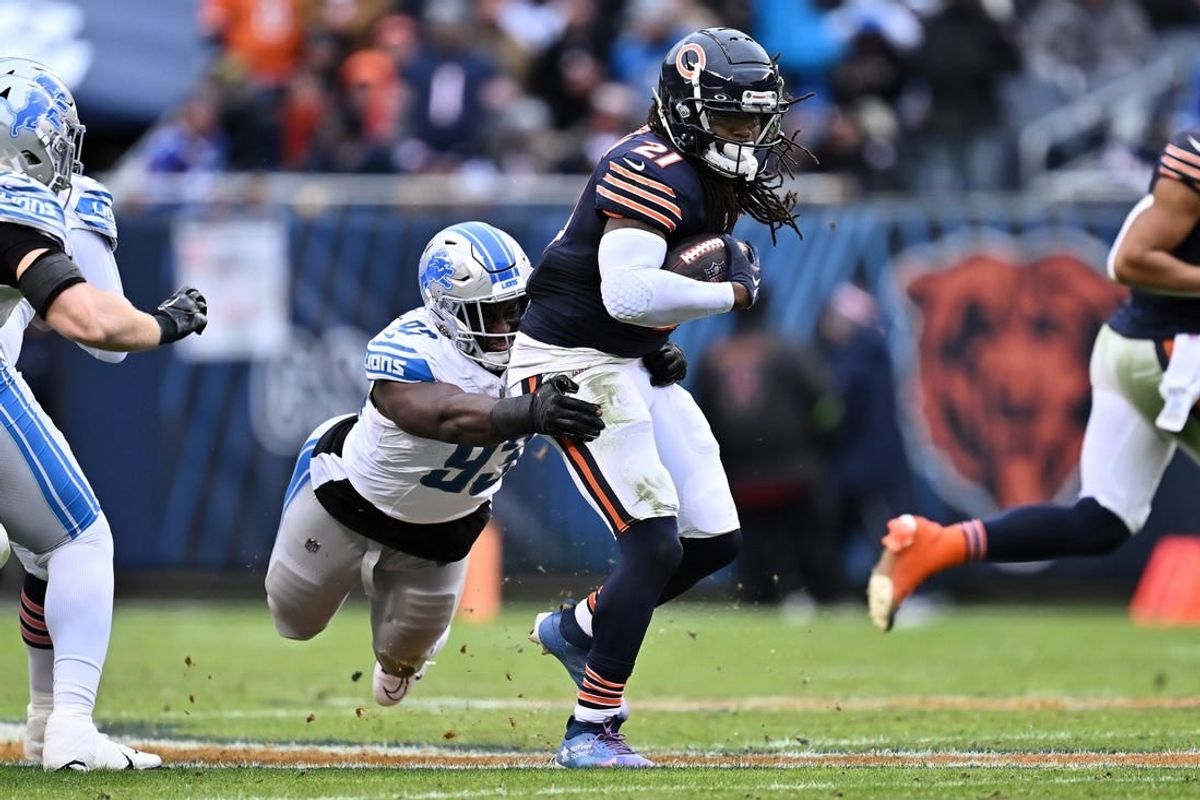 Dec 10, 2023; Chicago, Illinois, USA;  Detroit Lions defensive lineman Josh Paschal (93) hangs on to Chicago Bears running back D'Onta Foreman (21) to make the tackle in the second half at Soldier Field.