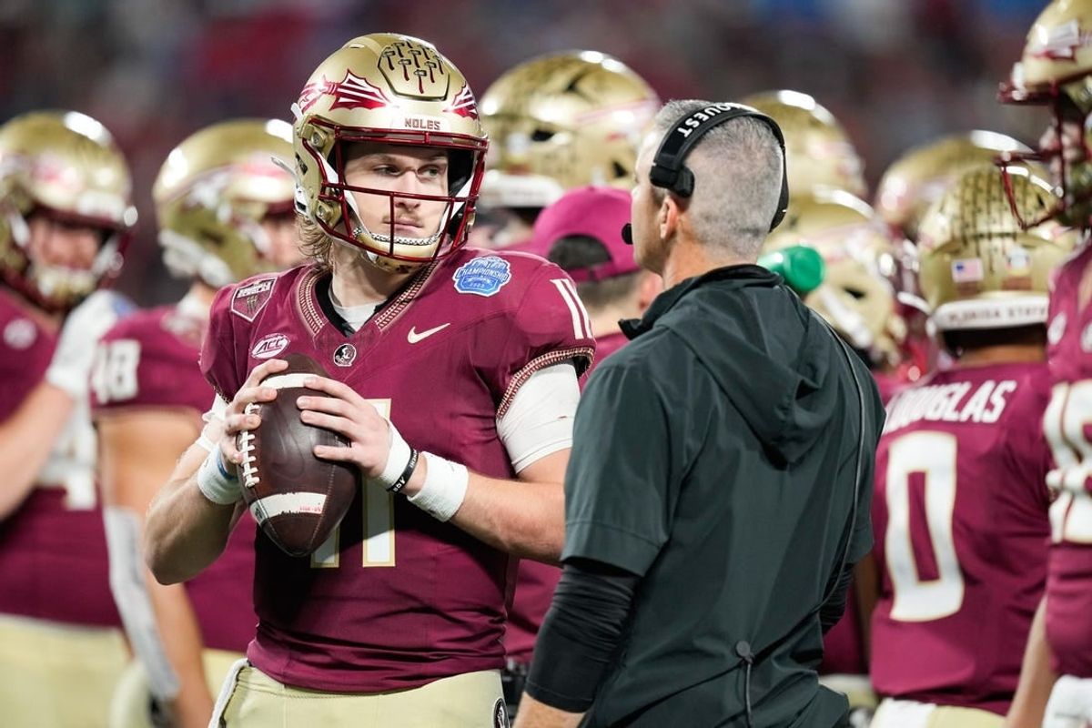 Dec 2, 2023; Charlotte, NC, USA; Florida State Seminoles quarterback Brock Glenn (11) speaks to head coach Mike Norvell on the sidelines during the third quarter against the Louisville Cardinals at Bank of America Stadium.