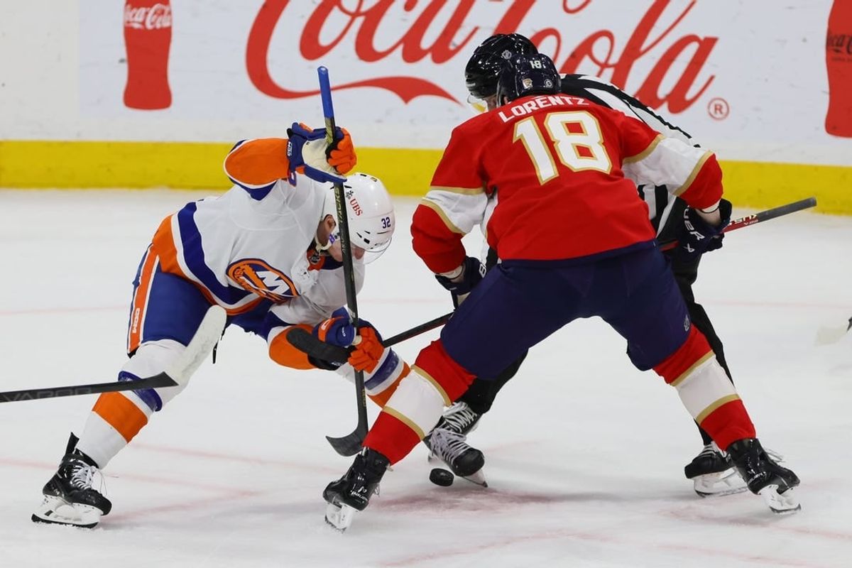 Mar 28, 2024; Sunrise, Florida, USA; New York Islanders center Kyle MacLean (32) and Florida Panthers center Steven Lorentz (18) face-off during the first period at Amerant Bank Arena.