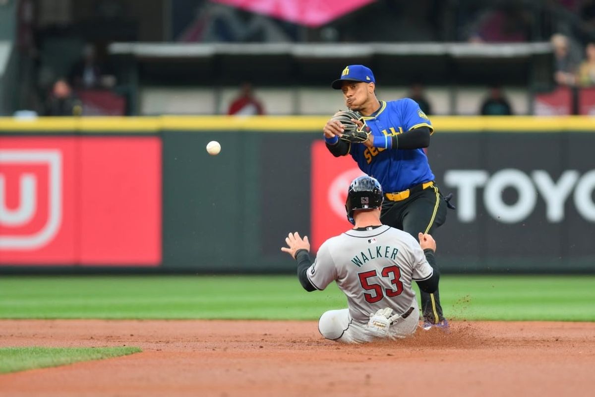 Apr 26, 2024; Seattle, Washington, USA; Seattle Mariners second baseman Jorge Polanco (7) throws the ball over Arizona Diamondbacks first baseman Christian Walker (53) to complete a double play during the second inning at T-Mobile Park.
