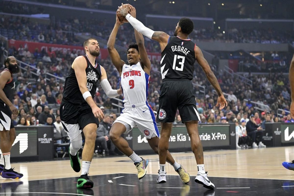 Feb 10, 2024; Los Angeles, California, USA;  Detroit Pistons forward Ausar Thompson (9) is defended by Los Angeles Clippers center Ivica Zubac (40) and forward Paul George (13) as he drives to the basket in the first half at Crypto.com Arena.