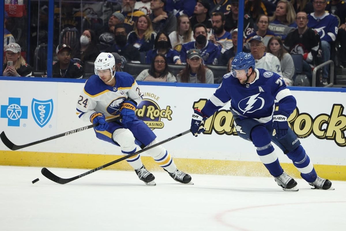 Feb 29, 2024; Tampa, Florida, USA;  Tampa Bay Lightning defenseman Victor Hedman (77) and Buffalo Sabres center Dylan Cozens (24) fight for the puck in the second period at Amalie Arena.