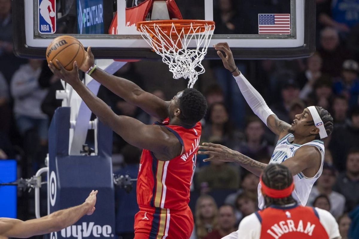 Jan 3, 2024; Minneapolis, Minnesota, USA; New Orleans Pelicans forward Zion Williamson (1) drives to the basket and shoots the ball past Minnesota Timberwolves guard Nickeil Alexander-Walker (9) in the first half at Target Center.