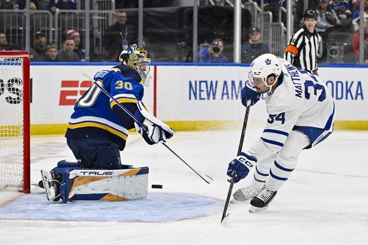Feb 19, 2024; St. Louis, Missouri, USA;  Toronto Maple Leafs center Auston Matthews (34) shoots against St. Louis Blues goaltender Joel Hofer (30) during the first period at Enterprise Center.