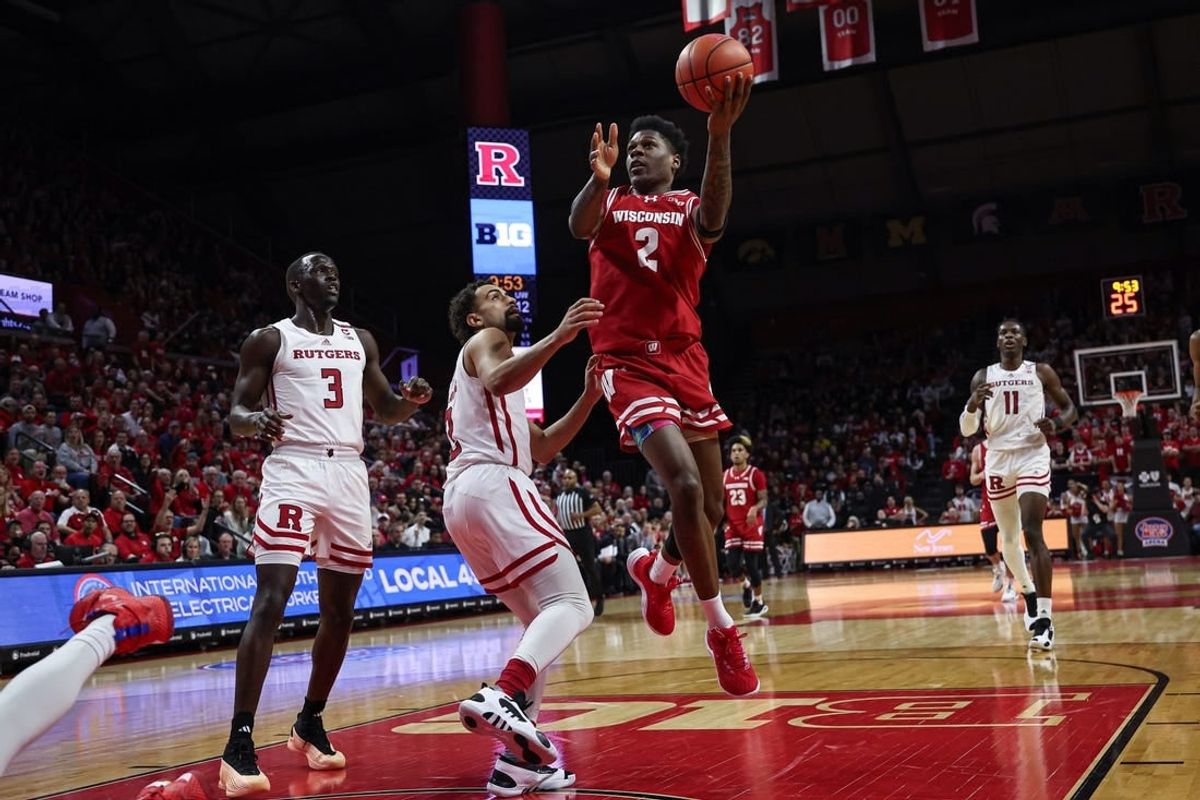 Feb 10, 2024; Piscataway, New Jersey, USA; Wisconsin Badgers guard AJ Storr (2) drives for a shot against Rutgers Scarlet Knights guard Noah Fernandes (2) and forward Mawot Mag (3) during the first half at Jersey Mike's Arena.