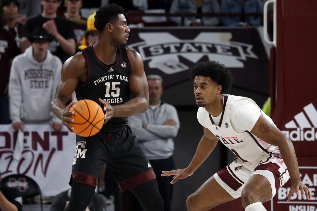 Feb 25, 2023; Starkville, Mississippi, USA; Aggies forward Henry Coleman III (15) handles the ball as Mississippi State Bulldogs forward Tolu Smith (1) defends during the first half at Humphrey Coliseum.