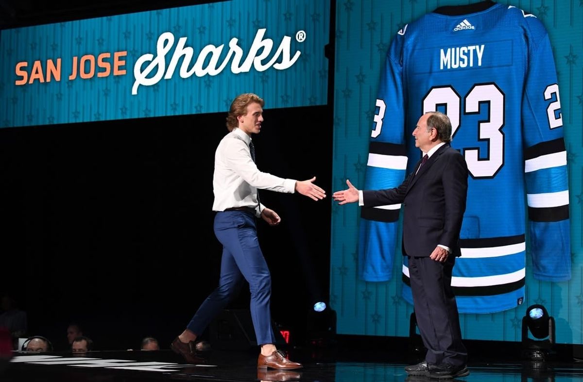 Jun 28, 2023; Nashville, Tennessee, USA; San Jose Sharks draft pick Quentin Musty shakes hands with NHL commissioner Gary Bettman after being selected with the twenty sixth pick in round one of the 2023 NHL Draft at Bridgestone Arena.