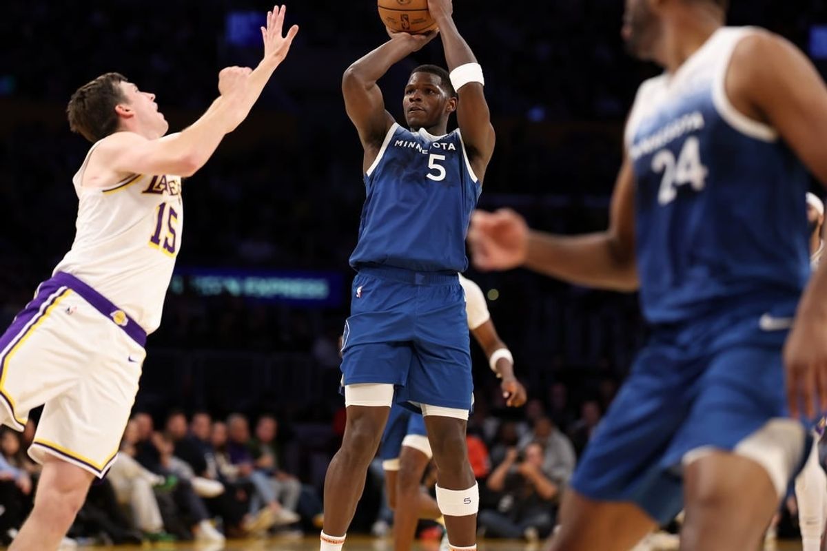Mar 10, 2024; Los Angeles, California, USA;  Minnesota Timberwolves guard Anthony Edwards (5) shoots the ball over Los Angeles Lakers guard Austin Reaves (15) during the fourth quarter at Crypto.com Arena.