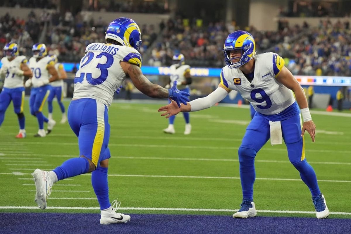 Los Angeles Rams running back Kyren Williams (23) celebrates with quarterback Matthew Stafford (9) in the fourth quarter against the Cleveland Browns SoFi Stadium.
