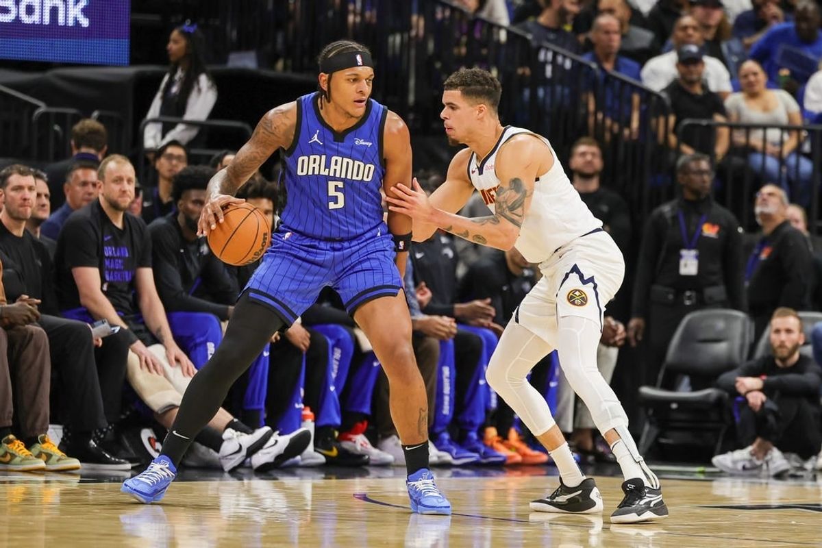 Nov 22, 2023; Orlando, Florida, USA; Denver Nuggets forward Michael Porter Jr. (1) defends Orlando Magic forward Paolo Banchero (5) during the first quarter at Amway Center.