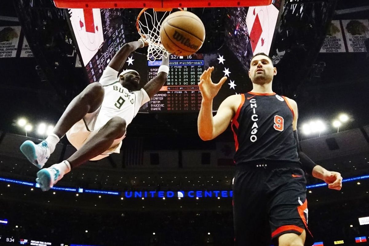 Mar 1, 2024; Chicago, Illinois, USA; Milwaukee Bucks forward Bobby Portis (9) dunks the ball as Chicago Bulls center Nikola Vucevic (9) stands nearby during the first quarter at United Center.