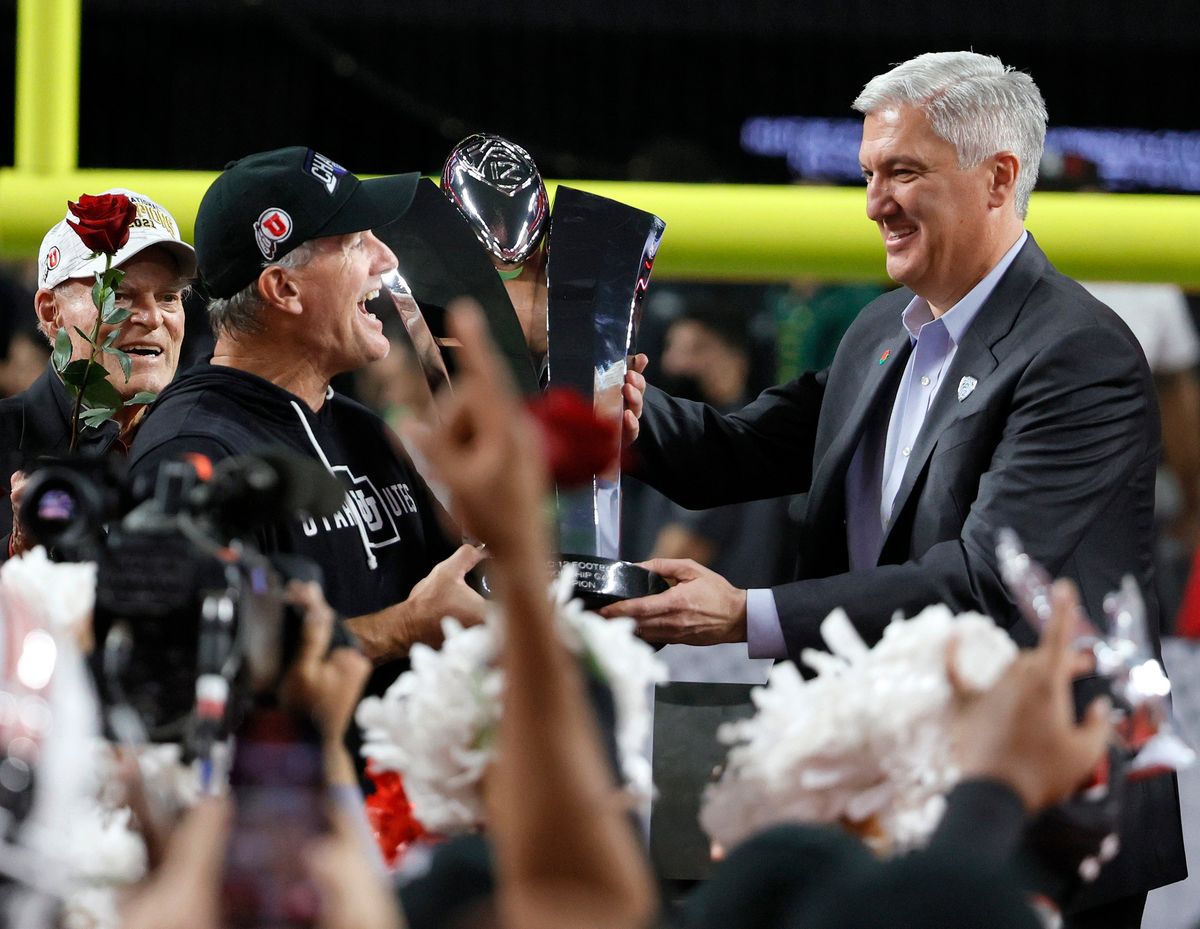 Pac-12 commissioner  George Kliavkoff, right, thinks scheduling college football games nine years in advance is bananas. He’s right.