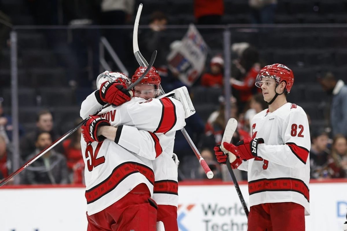 Jan 5, 2024; Washington, District of Columbia, USA; Carolina Hurricanes goaltender Pyotr Kochetkov (52) celebrates with Hurricanes right wing Andrei Svechnikov (37) after their game against the Washington Capitals at Capital One Arena.