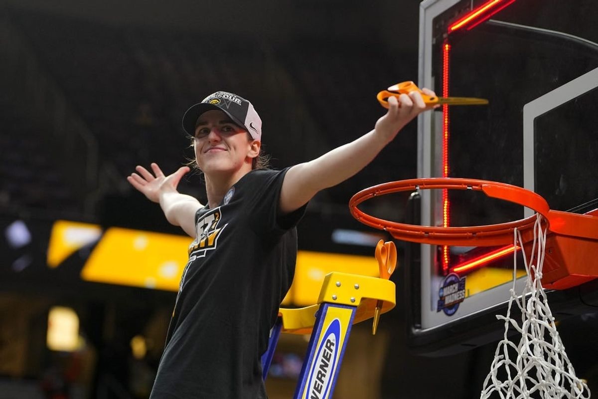 Apr 1, 2024; Albany, NY, USA; Iowa Hawkeyes guard Caitlin Clark (22) cuts the net after defeating the LSU Lady Tigers in the finals of the Albany Regional in the 2024 NCAA Tournament at MVP Arena.
