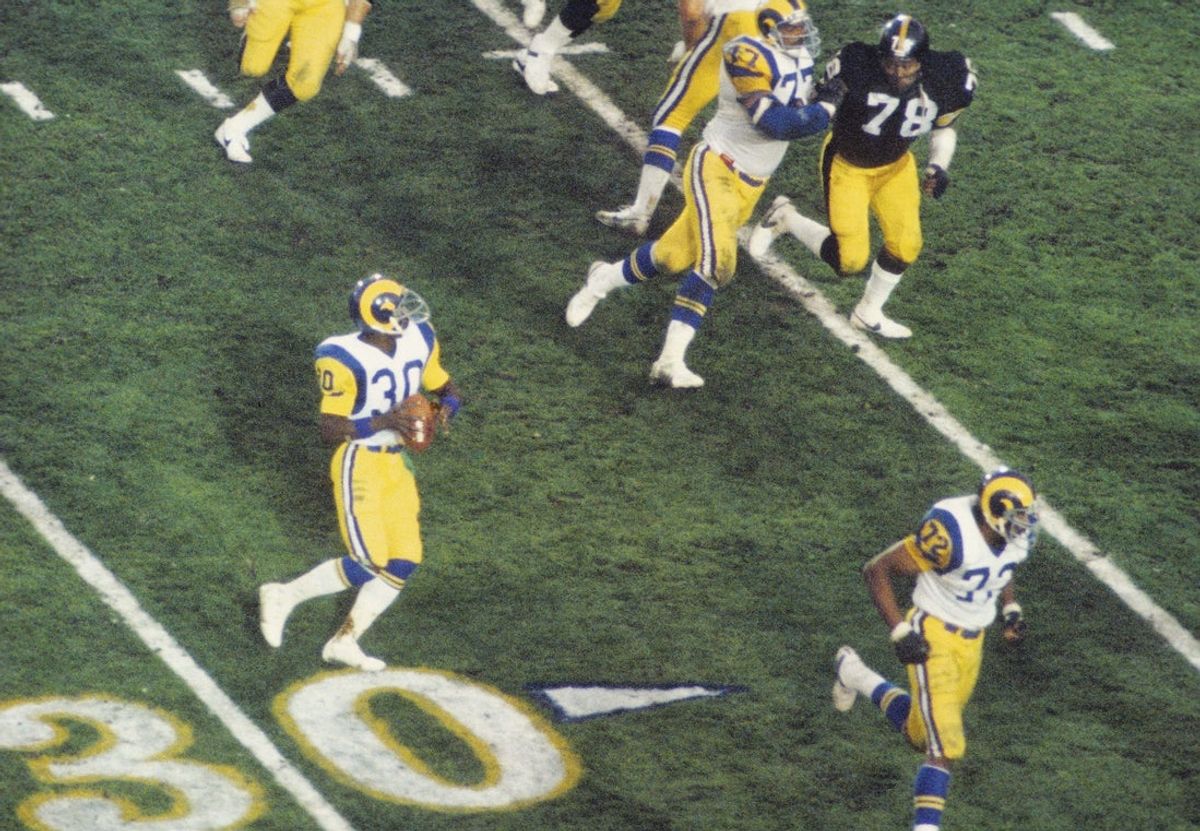 Jan 20, 1980; Pasadena, CA, USA; FILE PHOTO; Los Angeles Rams running back Lawrence McCutcheon (30) throws a touchdown pass to receiver Ron Smith (not pictured) on a trick play against the Pittsburgh Steelers during Super Bowl XIV at the Rose Bowl. The Steelers defeated the Rams 31-19. Mandatory Credit: Manny Rubio-Imagn Images