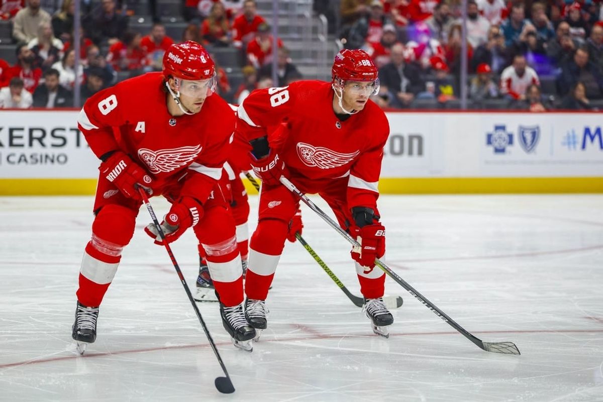 Dec 7, 2023; Detroit, Michigan, USA; Detroit Red Wings right wing Patrick Kane (88) and Detroit Red Wings defenseman Ben Chiarot (8) look on before a face off in the first period at Little Caesars Arena.