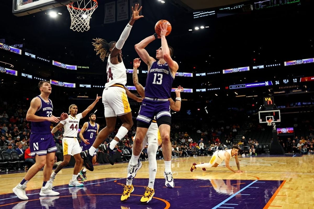 Dec 20, 2023; Phoenix, Arizona, USA; Northwestern Wildcats guard Brooks Barnhizer (13) shoots the ball against Arizona State Sun Devils forward Bryant Selebangue (24) during the first half during the Hall of Series at Footprint Center.