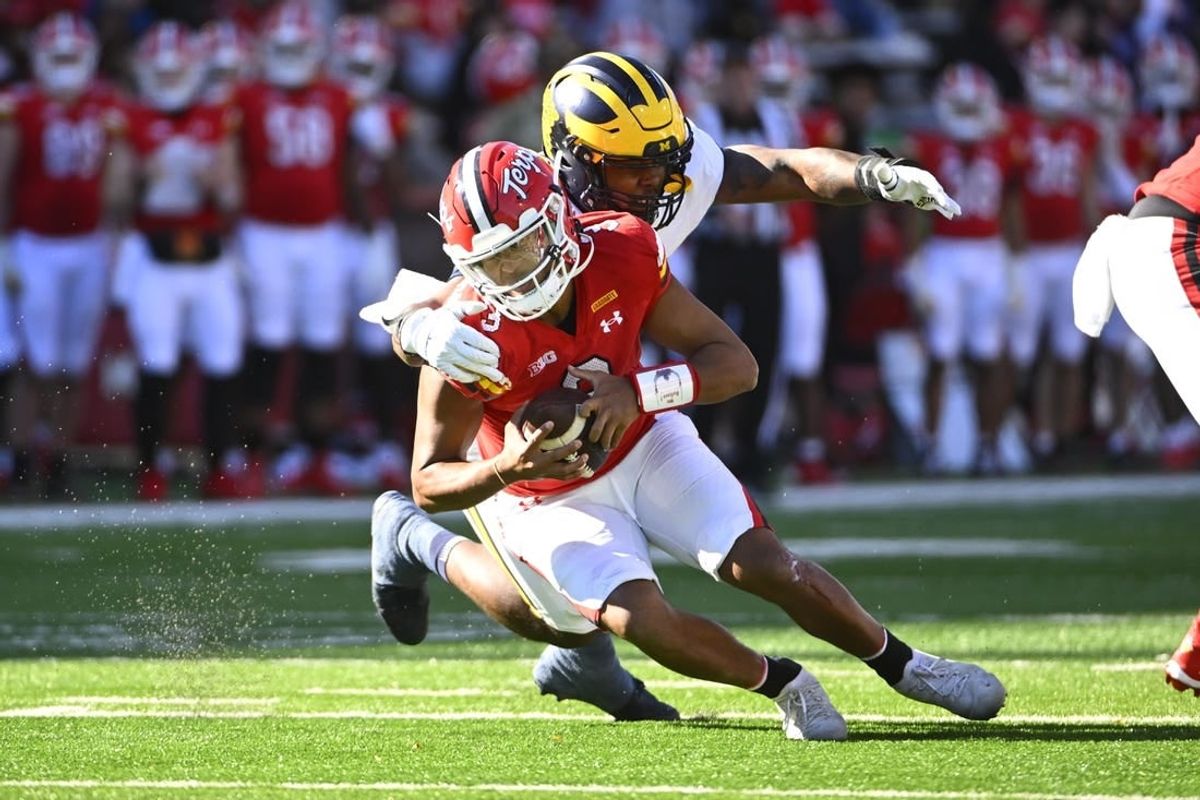 Nov 18, 2023; College Park, Maryland, USA; Michigan Wolverines defensive end Jaylen Harrell (32) sacks Maryland Terrapins quarterback Taulia Tagovailoa (3) during the first half at SECU Stadium.