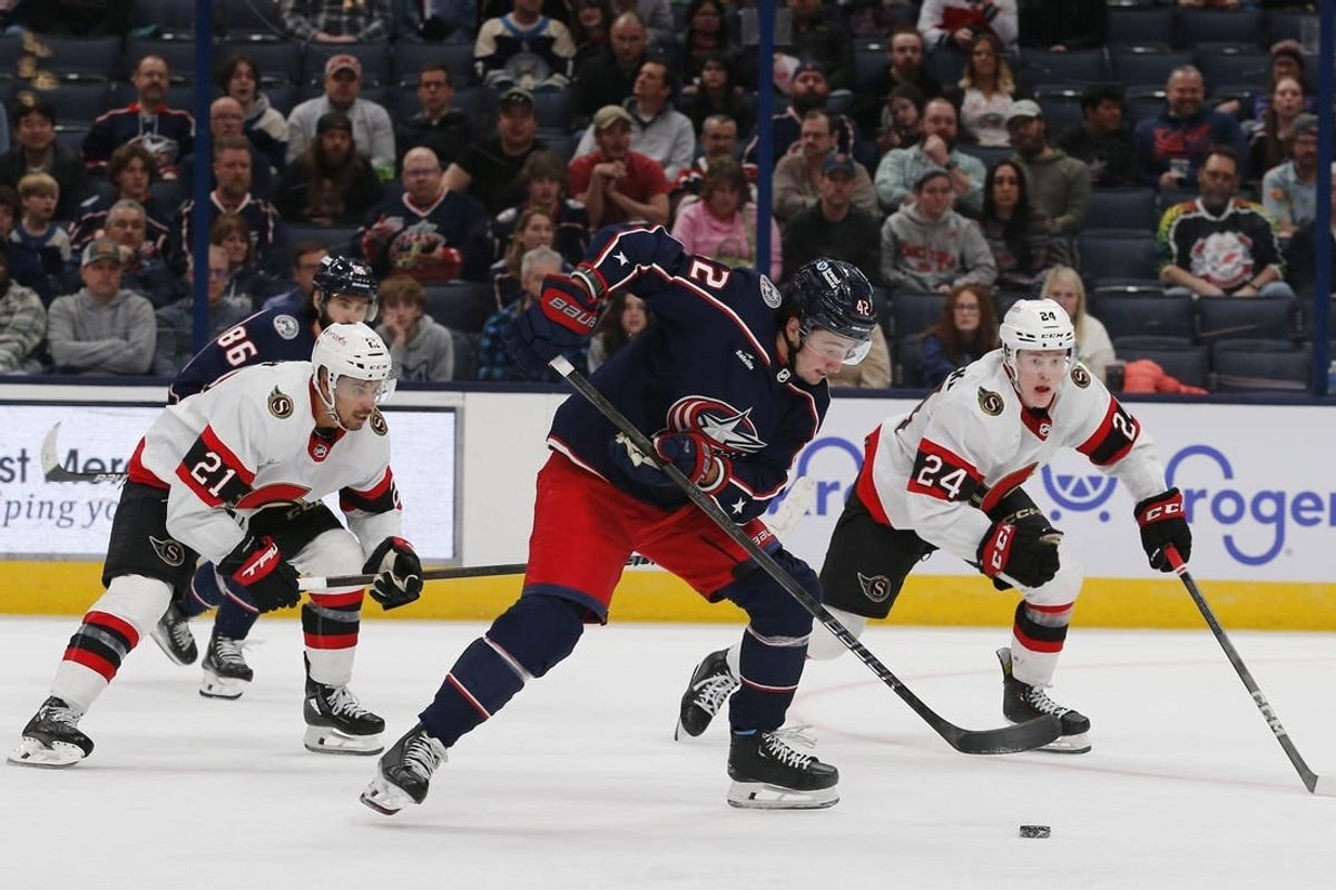 Mar 14, 2024; Columbus, Ohio, USA; Columbus Blue Jackets center Alexander Texier (42) grabs a loose puck as Ottawa Senators defenseman Jacob Bernard-Docker (24) trails the play during the third period at Nationwide Arena.