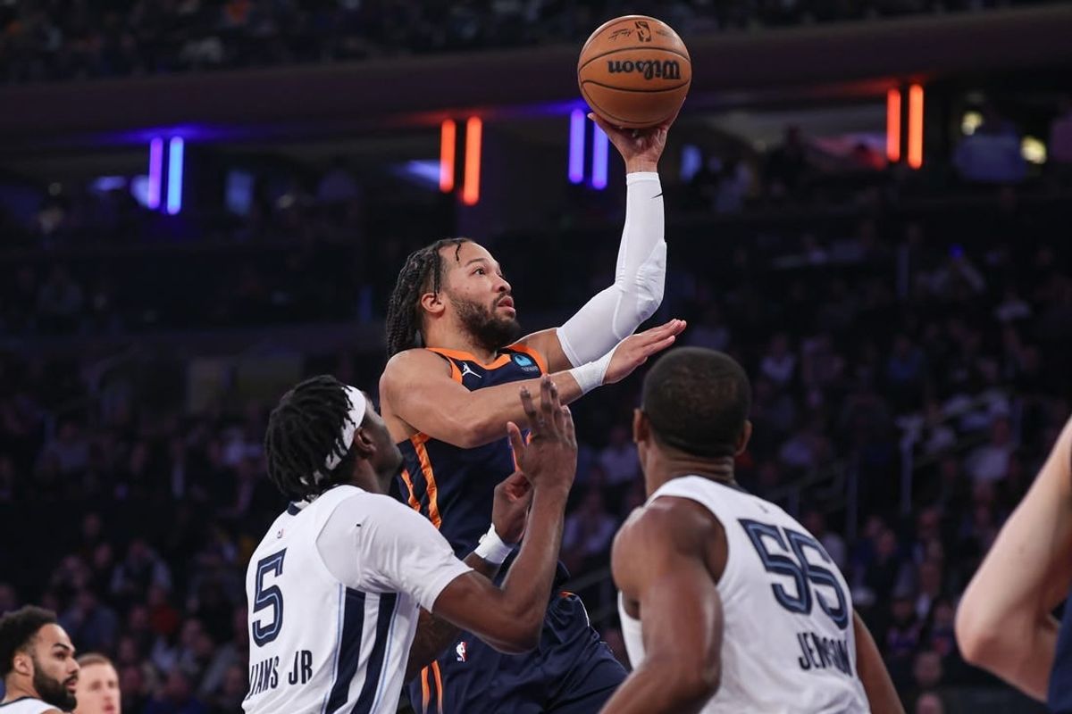 Feb 6, 2024; New York, New York, USA; New York Knicks guard Jalen Brunson (11) drives to the basket against Memphis Grizzlies forward Vince Williams Jr. and center Trey Jemison (55) during the first quarter at Madison Square Garden.