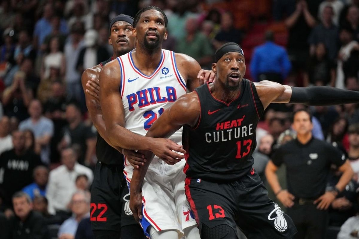 Apr 4, 2024; Miami, Florida, USA;  Miami Heat forward Jimmy Butler (22), Philadelphia 76ers center Joel Embiid (21) and Miami Heat center Bam Adebayo (13) box-out during free throw during the second half at Kaseya Center.