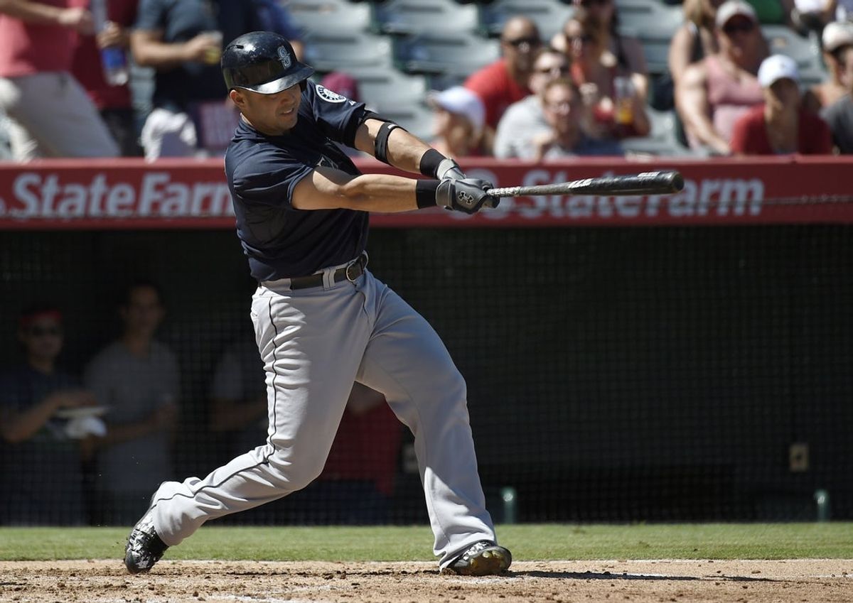 Sep 27, 2015; Anaheim, CA, USA; Seattle Mariners first baseman Jesus Montero (63) hits a RBI single against the Los Angeles Angels during the fourth inning at Angel Stadium of Anaheim. Mandatory Credit: Kelvin Kuo-Imagn Images