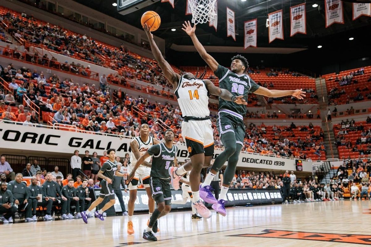 Feb 3, 2024; Stillwater, Oklahoma, USA; Oklahoma State Cowboys guard Jamyron Keller (14) shoots the ball around Kansas State Wildcats forward Jerrell Colbert (20) during the first half at Gallagher-Iba Arena.