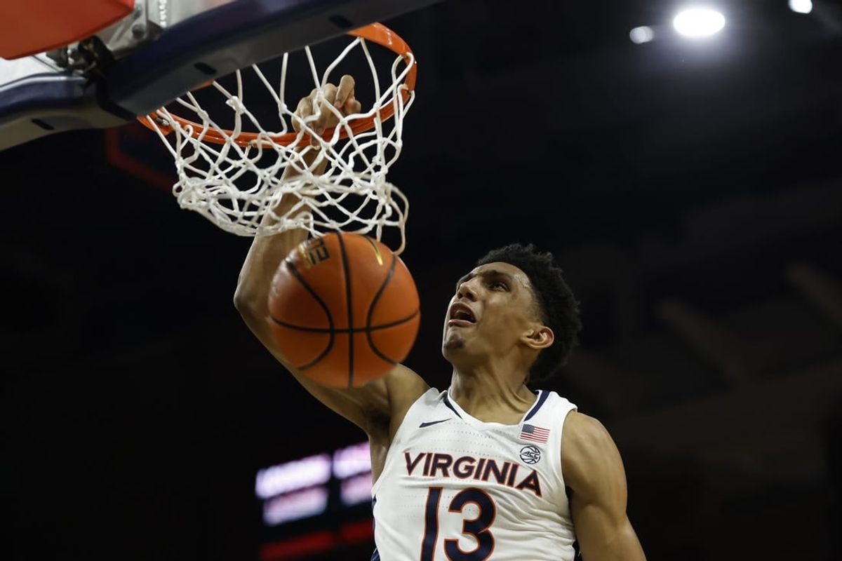 Jan 24, 2024; Charlottesville, Virginia, USA; Virginia Cavaliers guard Ryan Dunn (13) dunks the ball against the North Carolina State Wolfpack in overtime at John Paul Jones Arena.