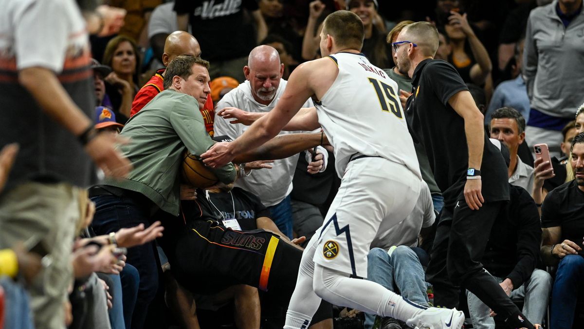 Nikola Jokic doing his best to retrieve the ball from a man-child  who thinks he’s part of the game.