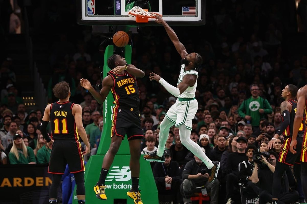 Nov 26, 2023; Boston, Massachusetts, USA; Boston Celtics guard Jaylen Brown (7) dunks over Atlanta Hawks center Clint Capela (15) during the second quarter at TD Garden.