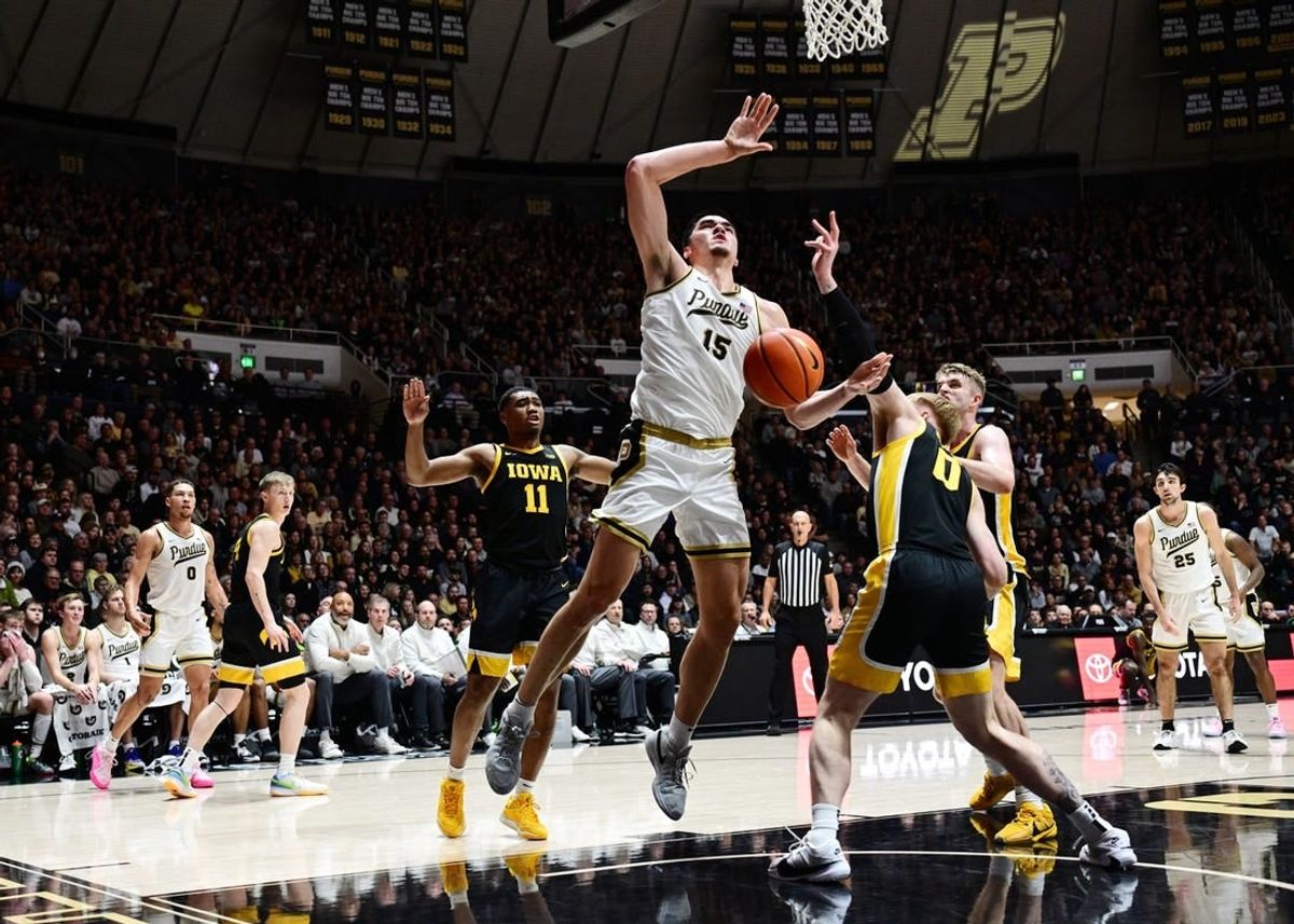 Dec 4, 2023; West Lafayette, Indiana, USA; Iowa Hawkeyes center Even Brauns (0) knocks the ball away from Purdue Boilermakers center Zach Edey (15) during the second half at Mackey Arena.
