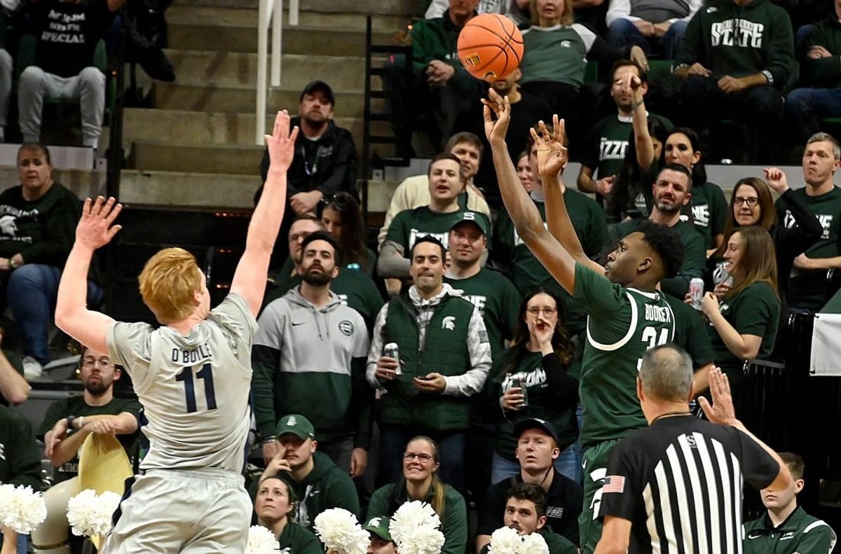 Jan 4, 2024; East Lansing, Michigan, USA; Michigan State Spartans forward Xavier Booker (34) shoots past Penn State Nittany Lions forward Leo O'Boyle (11) during the first half at Jack Breslin Student Events Center.