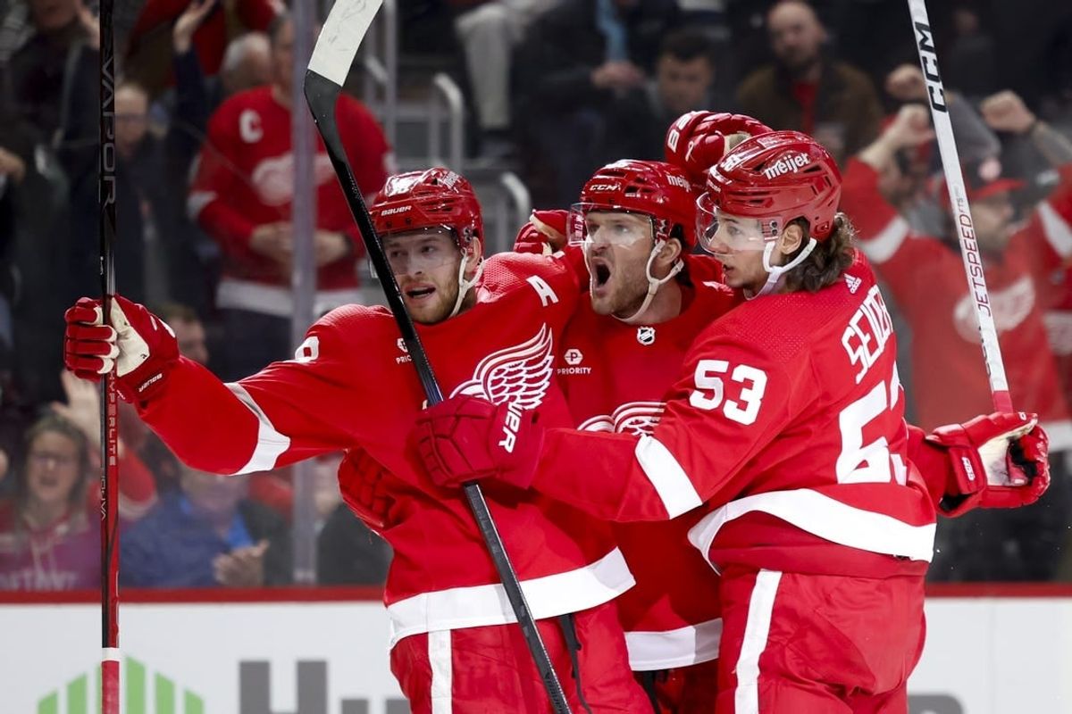 Mar 16, 2024; Detroit, Michigan, USA;  Detroit Red Wings right wing Christian Fischer (36) receives congratulations from center Andrew Copp (18) and defenseman Moritz Seider (53) after scoring in the second period against the Buffalo Sabres at Little Caesars Arena.