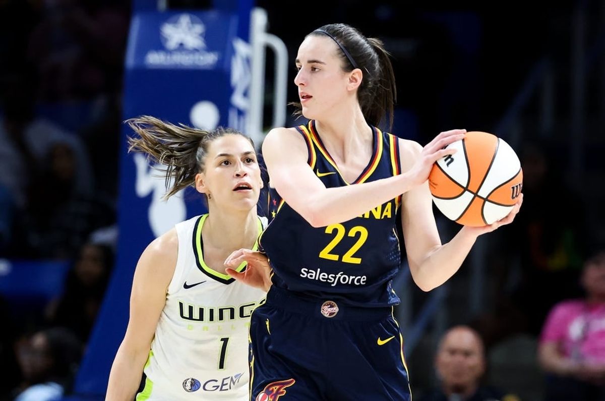 May 3, 2024; Dallas, Texas, USA; Indiana Fever guard Caitlin Clark (22) controls the ball as Dallas Wings guard Ashley Joens (1) defends during the second half at College Park Center.