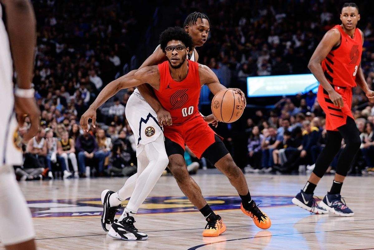 Feb 4, 2024; Denver, Colorado, USA; Portland Trail Blazers guard Scoot Henderson (00) controls the ball as Denver Nuggets forward Peyton Watson (8) guards in the third quarter at Ball Arena.