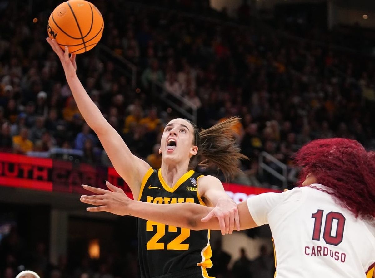 Iowa Hawkeyes guard Caitlin Clark (22) drives to the basket as South Carolina Gamecocks center Kamilla Cardoso (10) defends during the NCAA Tournament championship basketball game at Rocket Mortgage Fieldhouse, Sunday, April 7, 2024 in Cleveland.