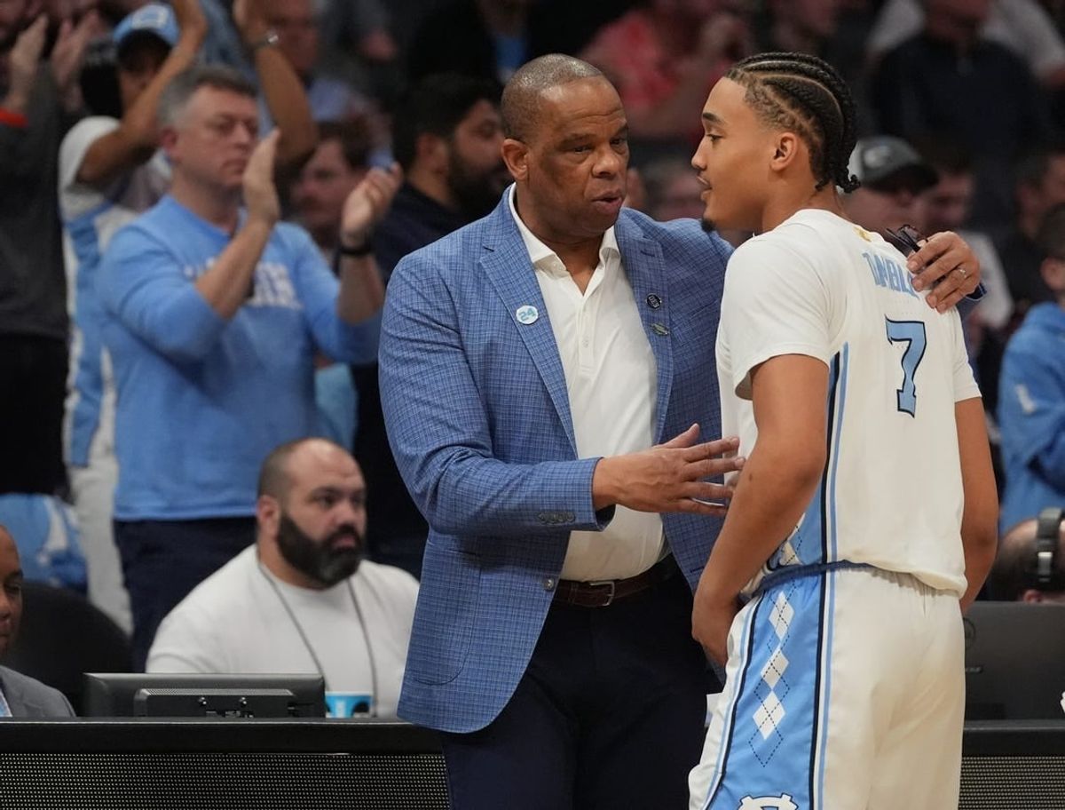 March 21, 2024, Charlotte, NC, USA;  North Carolina Tar Heels head coach Hubert Davis talks with guard Seth Trimble (7) as they play against the Wagner Seahawks in the first round of the 2024 NCAA Tournament at the Spectrum Center.