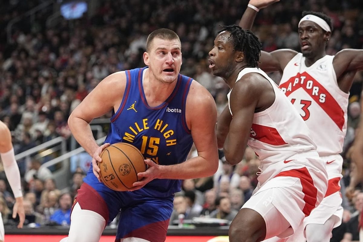 Dec 20, 2023; Toronto, Ontario, CAN; Denver Nuggets center Nikola Jokic (15) drives to the net against Toronto Raptors forward O.G. Anunoby (3) during the first half at Scotiabank Arena.