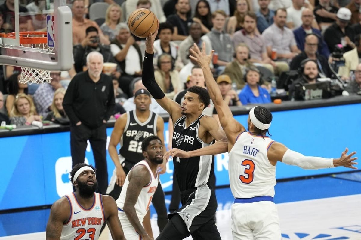 Mar 29, 2024; San Antonio, Texas, USA; San Antonio Spurs forward Victor Wembanyama (1) goes up to dunk over New York Knicks center Mitchell Robinson (23) and forward Josh Hart (3) during the first half at Frost Bank Center.