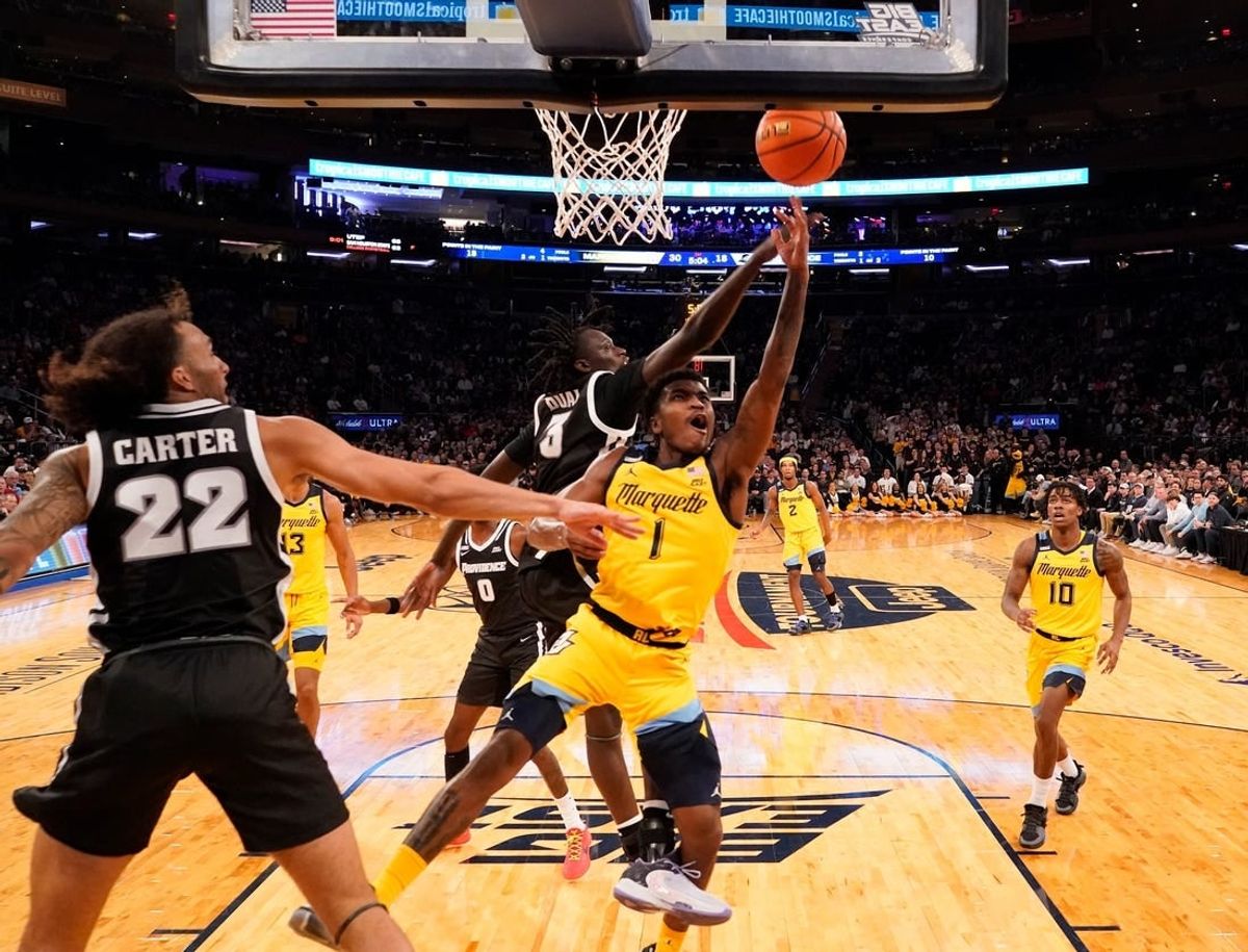 Mar 15, 2024; New York City, NY, USA;  Marquette Golden Eagles guard Kam Jones (1) shoots past Providence Friars guard Garwey Dual (3) during the first half at Madison Square Garden.
