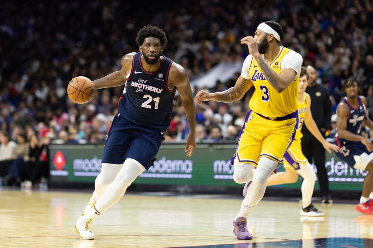 Nov 27, 2023; Philadelphia, Pennsylvania, USA; Philadelphia 76ers center Joel Embiid (21) dribbles the ball against Los Angeles Lakers forward Anthony Davis (3) during the third quarter at Wells Fargo Center.