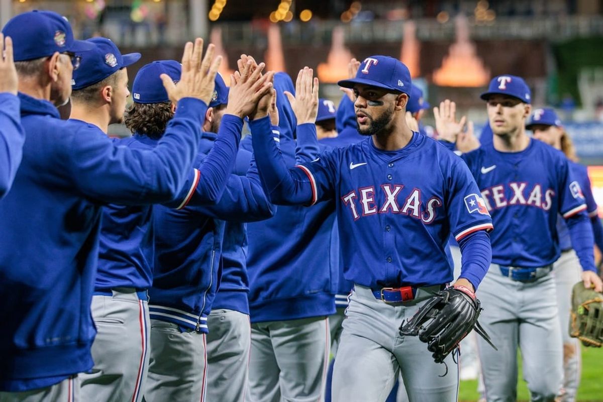 May 4, 2024; Kansas City, Missouri, USA; Texas Rangers outfielder Leody Taveras (3) high fives teammates after the game against the Kansas City Royals at Kauffman Stadium.