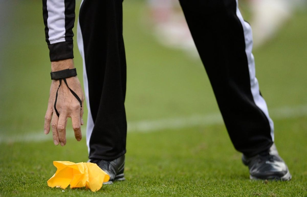 Nov 15, 2015; Denver, CO, USA; General view of a referee picking up a penalty flag during the second quarter of the game between the Kansas City Chiefs against the Denver Broncos at Sports Authority Field at Mile High. Mandatory Credit: Ron Chenoy-Imagn Images