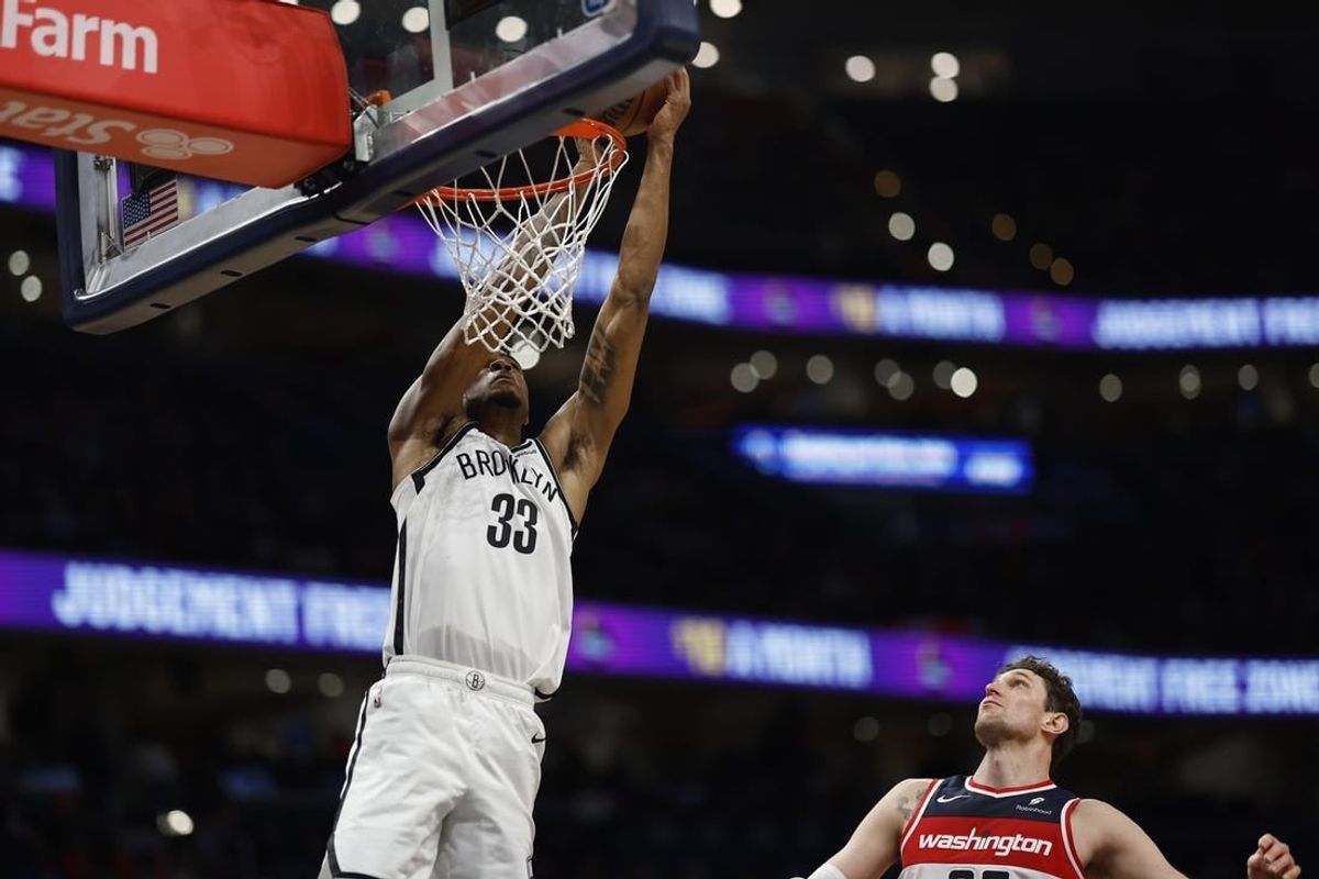 Dec 29, 2023; Washington, District of Columbia, USA; Brooklyn Nets center Nic Claxton (33) attempts to dunk the ball as Washington Wizards center Mike Muscala (35) looks on in the fourth quarter at Capital One Arena.