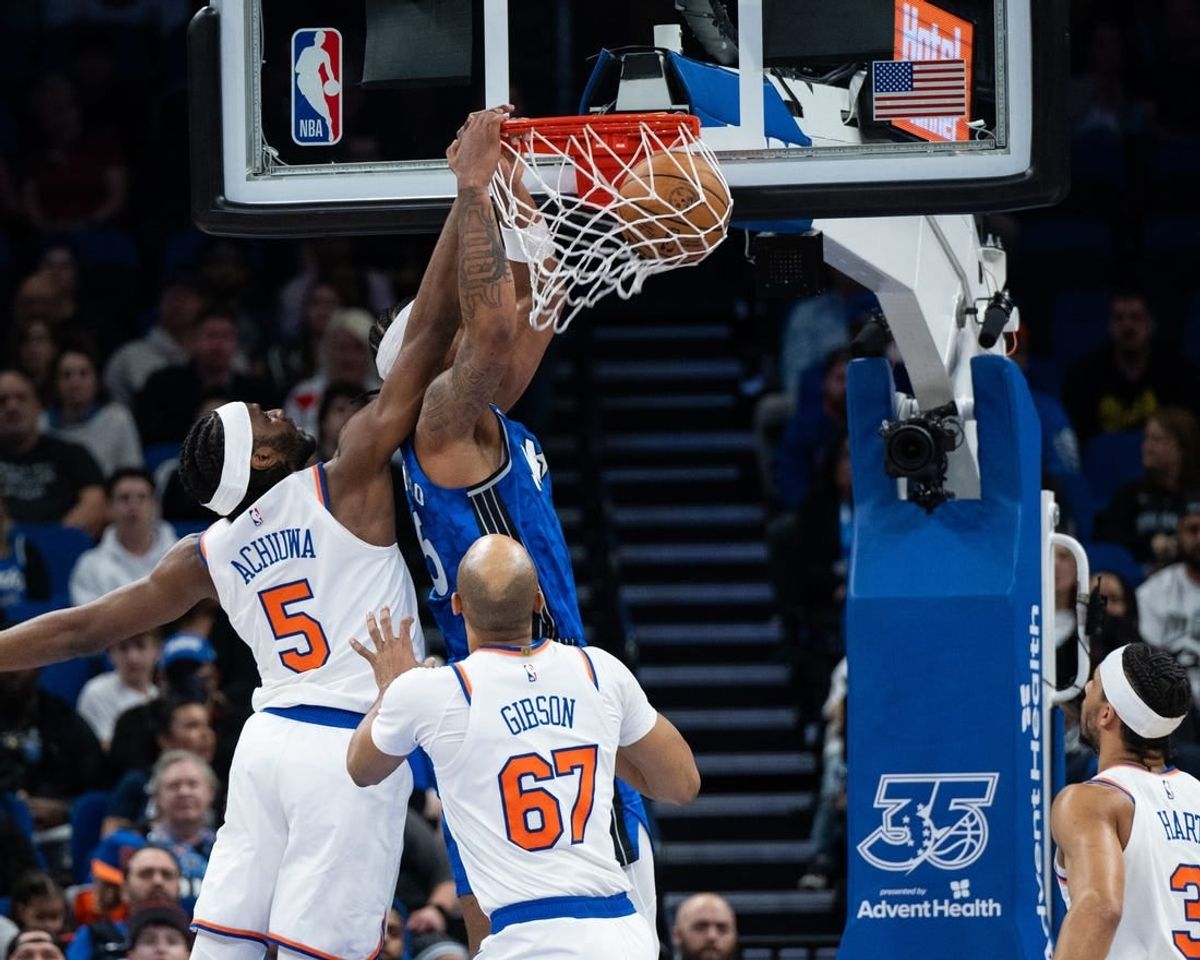 Feb 14, 2024; Orlando, Florida, USA; Orlando Magic forward Paolo Banchero (5) dunks the ball against New York Knicks forward Precious Achiuwa (5) in the second quarter at KIA Center.